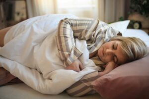 mid age woman sleeping on the bed